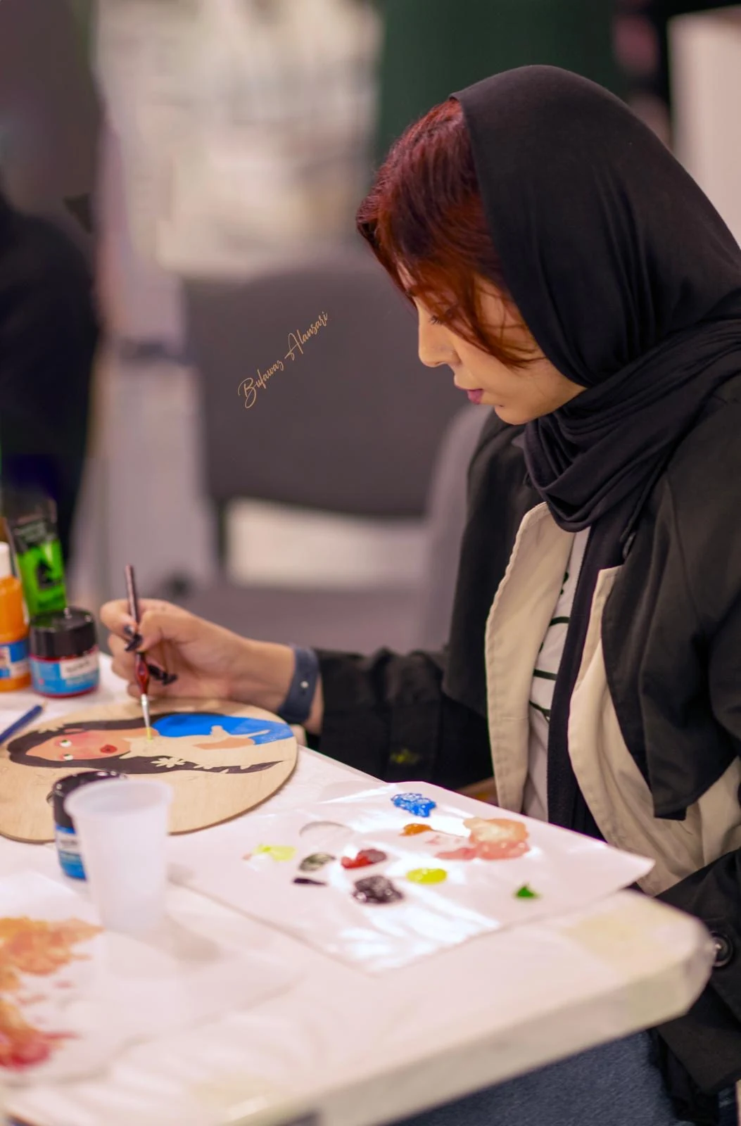 The artist painting in the studio